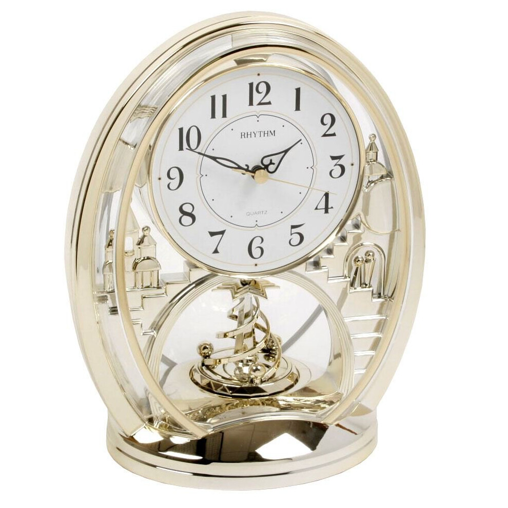 Rhythm Cont Mantel Clock - Oval Gilt Finish, Arabic Dial, Rotating Pend