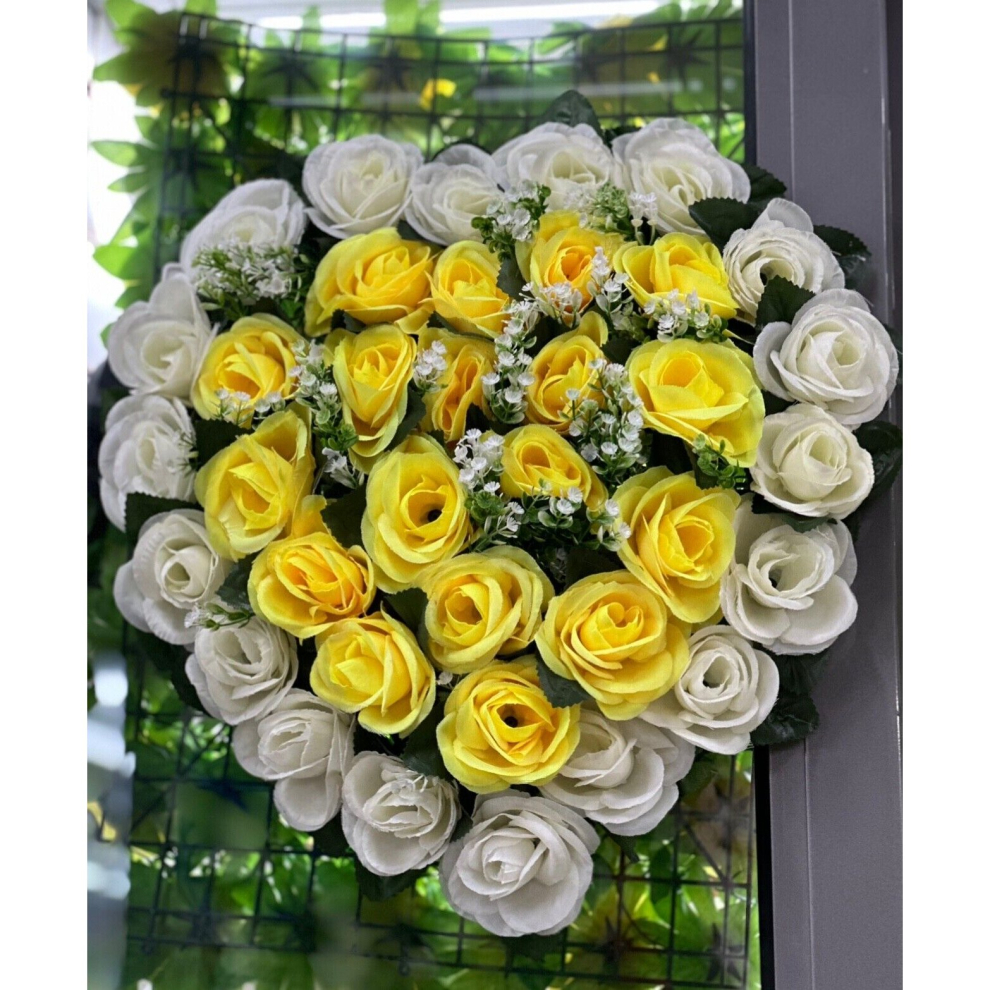 Artificial Rose flowers in the shape of a heart for a memorial grave or funeral