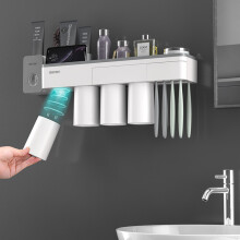 Supporto per spazzolini da denti magnetico multifunzionale con tazze per spremere il dentifricio scaffale per bathroom montaggio senza chiodi.