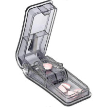 Medicine cutter with blade and storage compartment
