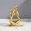 Gold Thinkers Resin Statue Reading Ornament, A 4