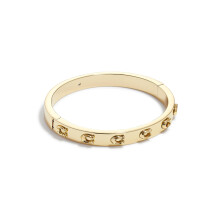 COACH Pegged C Logo Gehingde Bangle Armband Shiny Goud One Size