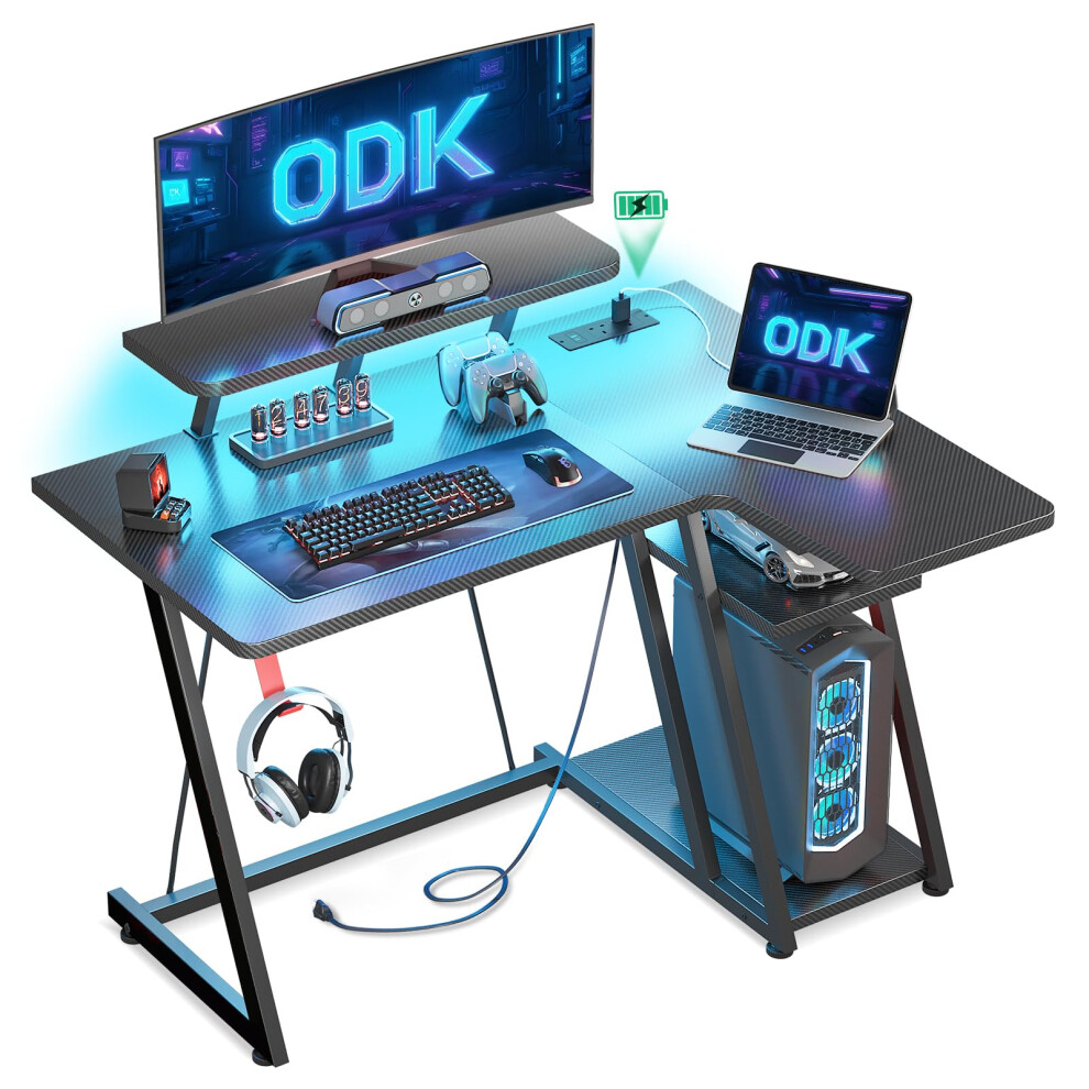 ODK L Shaped Gaming Desk with LED Lights & Power Outlets, Gaming Table with Monitor Stand, Corner Gaming Desk with Storage, Computer PC Desks Carbon
