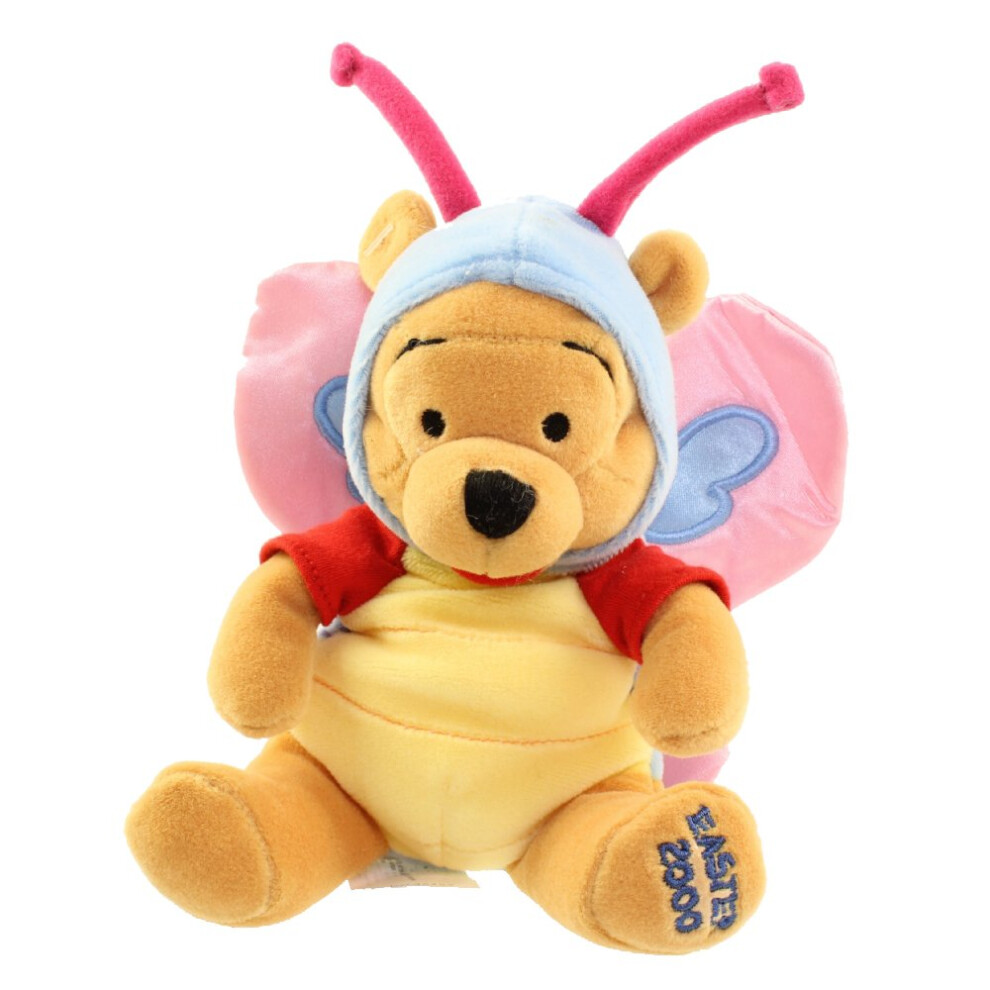 Winnie l'ourson en peluche avec un sac de haricots et un papillon
