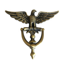 Antieke deurklopper van zinklegering met adelaarskop voor decoratie aan de voorkant van het huis. Ring voor meubelgrepen.