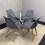 Round Glass Dining Table and 4 grey   Colour leather  Chairs 4