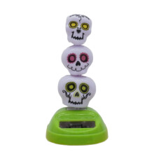 Dansfiguren op zonne-energie Autodashboard-Driekoppig monster
