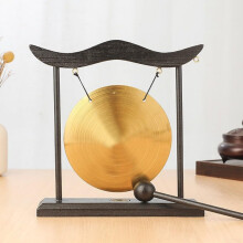 Traditional brass percussion instrument with a wooden base for daily use (A).