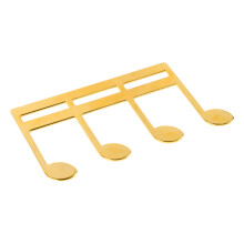 Metallisches Musikbuchclip mit goldener Oberfläche und Notenmuster für Klavier und Gitarre