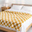 Yellow checkered flannel blanket with black and white 3