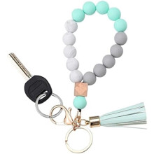 Bracelet porte-clés en silicone avec pompon en cuir et perles, idéal pour femme.