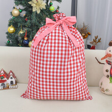 Kerstcadeautasjes, grote gebreide tas met kerstversiering en trekkoord, perfect om kerstavondcadeautjes in te pakken.