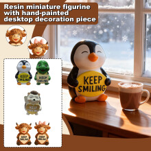 Keramisk pingvinfigur med "Bliv ved med at smile"-print