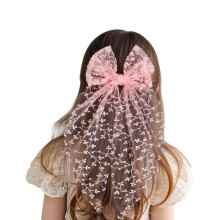 Elegante fermaglio per capelli con fiocco in pizzo e paillettes.