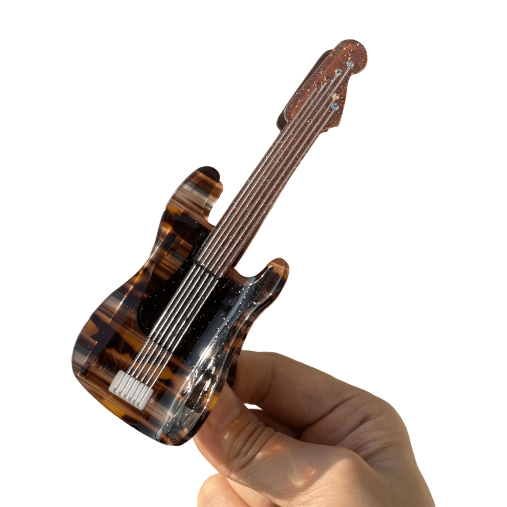 Saxophone-shaped hair clip with musical note design
