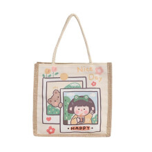 Sac cabas élégant en toile de coton au design esthétique, avec fermeture éclair et bandoulière.