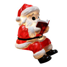 Figura de Papá Noel leyendo un libro, de resina con luz LED, 20 cm (8 pulgadas)
