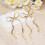 1Paar Gold Schleifen Dangle Ohrringe Kupfer Statement Schmuck 2