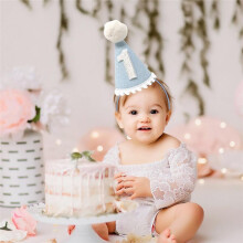 A Light   Hat with White Pom-Poms, Perfect for A Baby'S First Birthday Party.