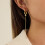 Boucles d'oreilles robustes avec pompons fluides et zircons 4