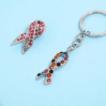 Creative and unique pink ribbon brooch keychain alloy drip pendant D1282