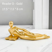 Złota żywiczna figura czytającej kobiety 17,5 cm