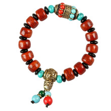 Elastische turquoise stenen armband met yakbotkralen voor-A