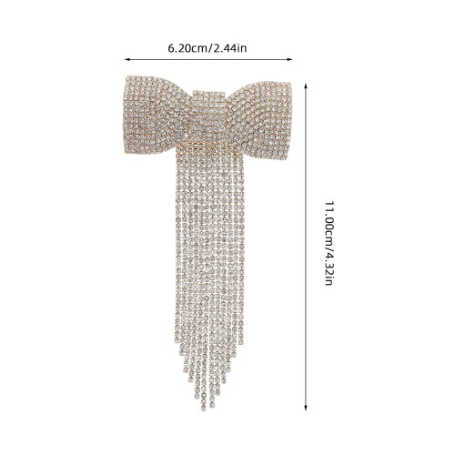 Presilha de cabelo dourada em metal com laço, strass e borla. 1