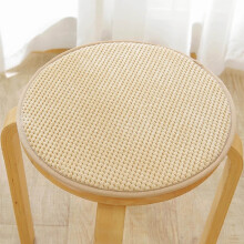 Cojín de asiento circular beige con borde cuadrado para uso en interiores.
