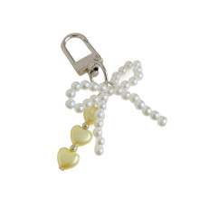 Llavero con lazo de perlas de moda, diseño en forma de corazón, dije ligero, accesorio para bolso, regalo compatible con amigos.