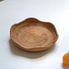 Panier de rangement rustique rond en rotin naturel tressé pour assiettes et autres objets. Fabrication artisanale.