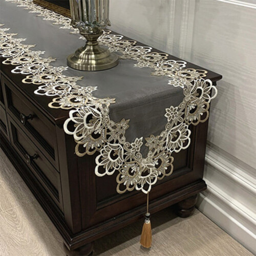 Oval lace table runner embroidered with tassels