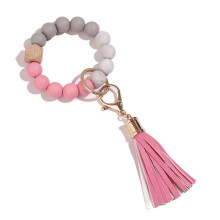 Porte-clés bracelet élastique, porte-clés en silicone de qualité supérieure avec perle, pompon en cuir et boucle métallique rotative,