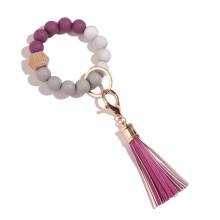 Porte-clés bracelet élastique, porte-clés en silicone de qualité supérieure avec perle, pompon en cuir et boucle métallique rotative,