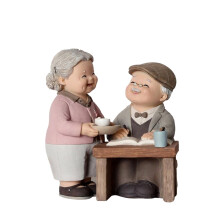 Estatueta de resina representando um casal de idosos para decoração de casa.