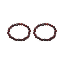 Bracelet unisexe composé de 2 perles rondes en bois brun de style bouddhiste et d'un cordon élastique.