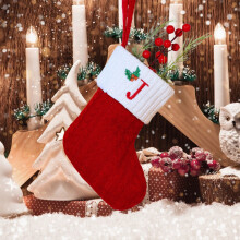 White knitted Christmas stockings with monogram embroidery,