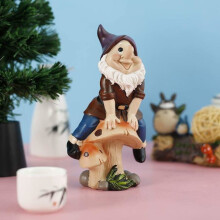 Resin garden gnome sitting on a mushroom, humorous decoration, compact size, fun gift for children.