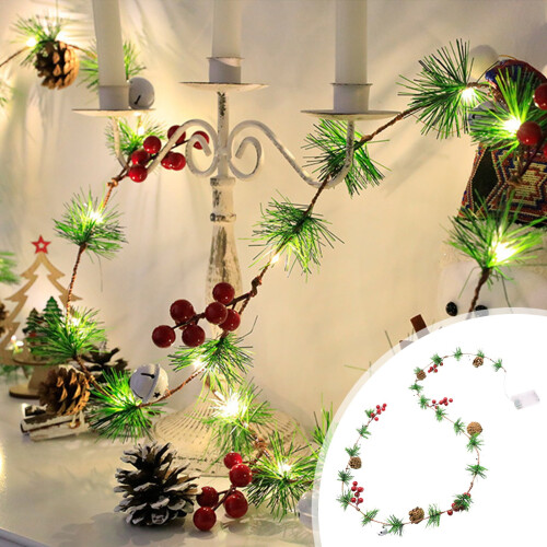 Christmas string lights with pine cones bells and berries