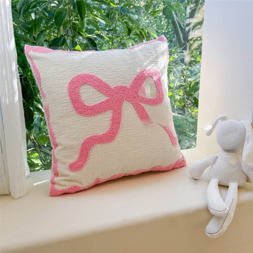 Almohada rosa con lazo de San Valentín y relleno de algodón comprimido.