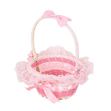 Cesto de armazenamento portátil rosa, pequeno, em plástico trançado.