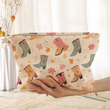 Corduroy cosmetica-organizer met bloemenprint en gouden ritssluiting.