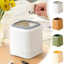 Small white trash can with swing-top lid