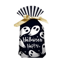 Halloween-käärepaperia ja karkkipusseja kurpitsakuviolla