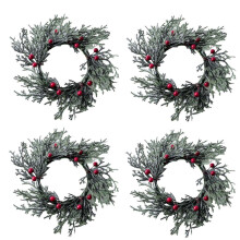 Christmas candle rings with pine needles and red berries