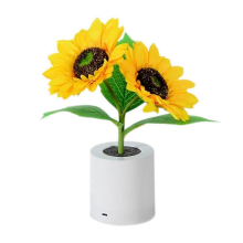 Lámpara de mesa con luz nocturna LED recargable con forma de girasol.