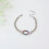 Pulseira oval de aço inoxidável e titânio com zircônia. 1