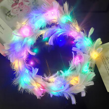 Fascia per capelli con fiori, glitter e piume d'angelo.
