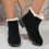 Botas femininas com laço, pretas, em nylon e elastano, cano médio e salto baixo. 5