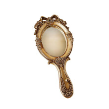 Vintage oval hand mirror with embossed floral design